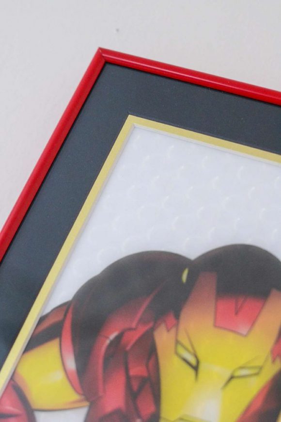 Red metal picture frame of Iron Man print