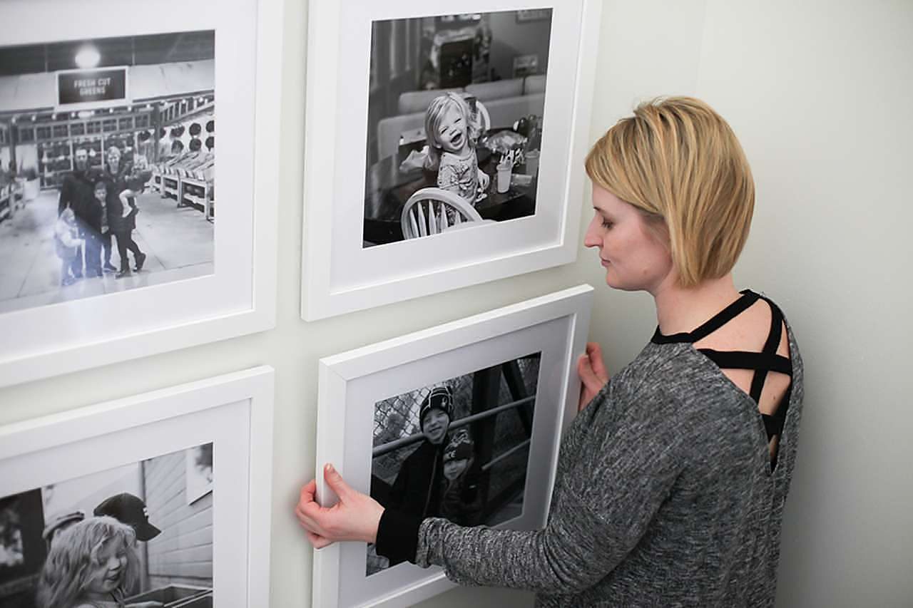 Black and white photos in white picture frames