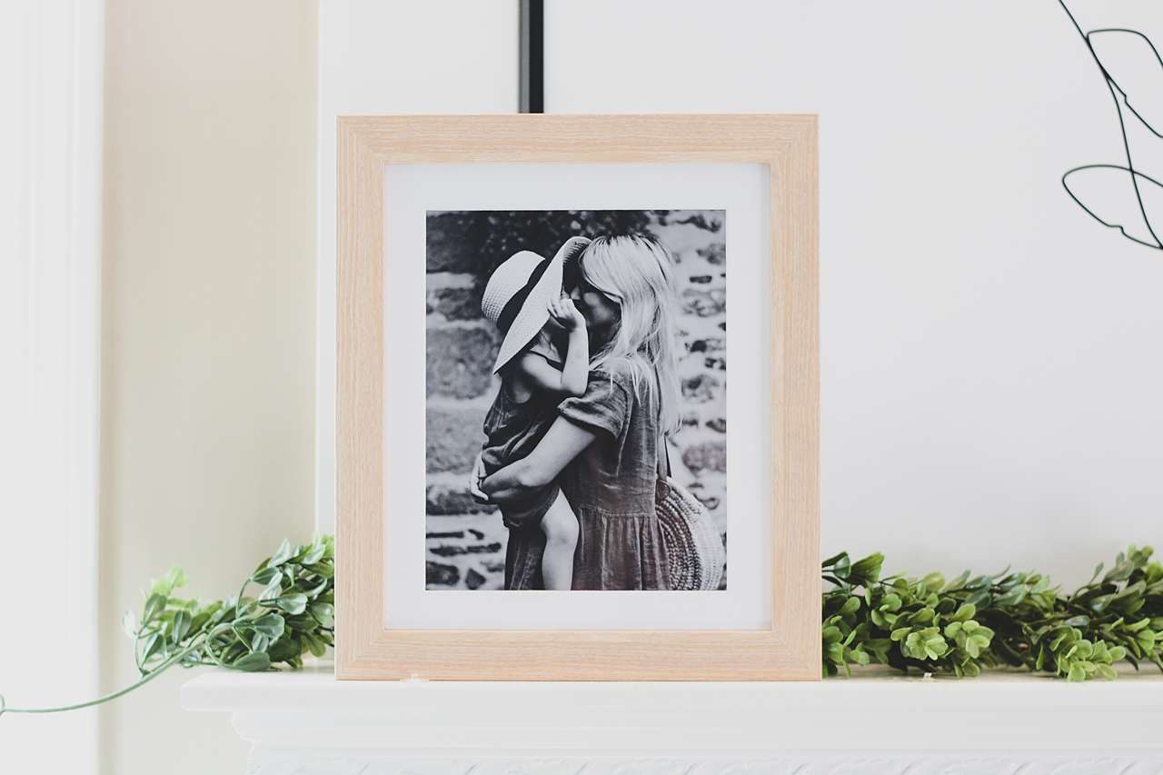 Honey colored frame with black and white photo of mother and child