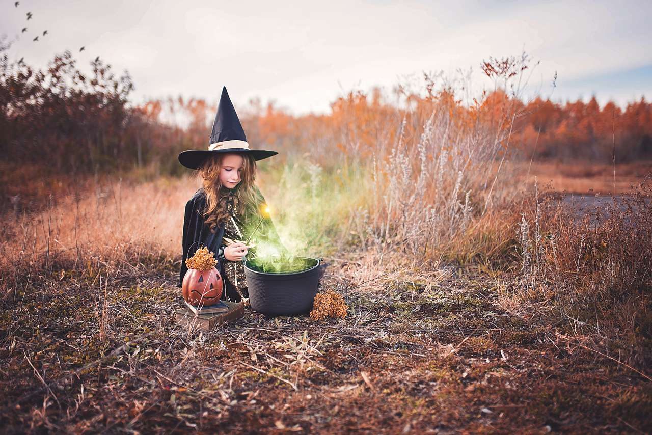 young girl dressed as a witch