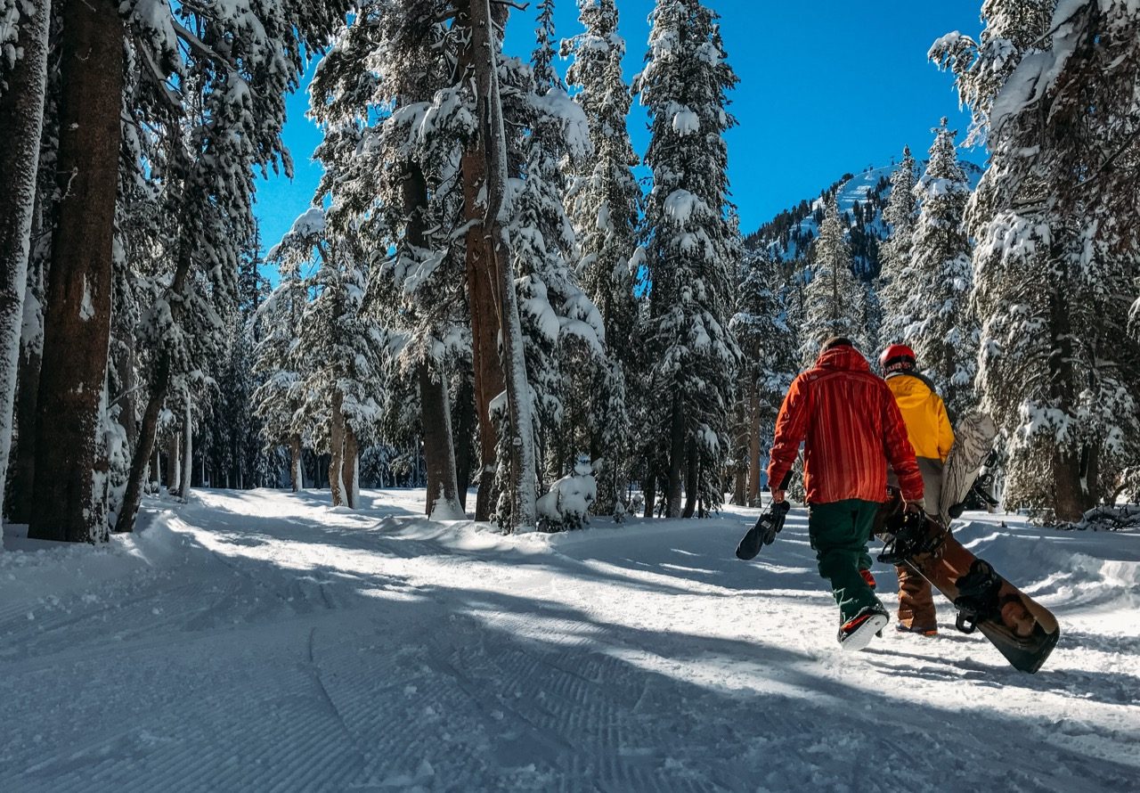 Snowboarders walking on the slope