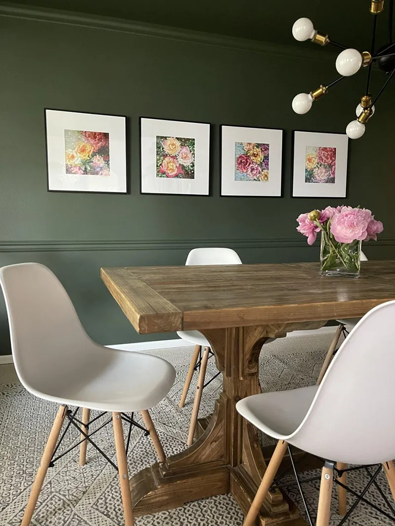 Modern office with multiple framed art pieces on the wall