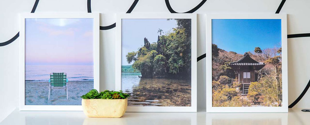 picture frames resting on an office desk