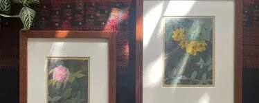 two art prints in wood picture frames