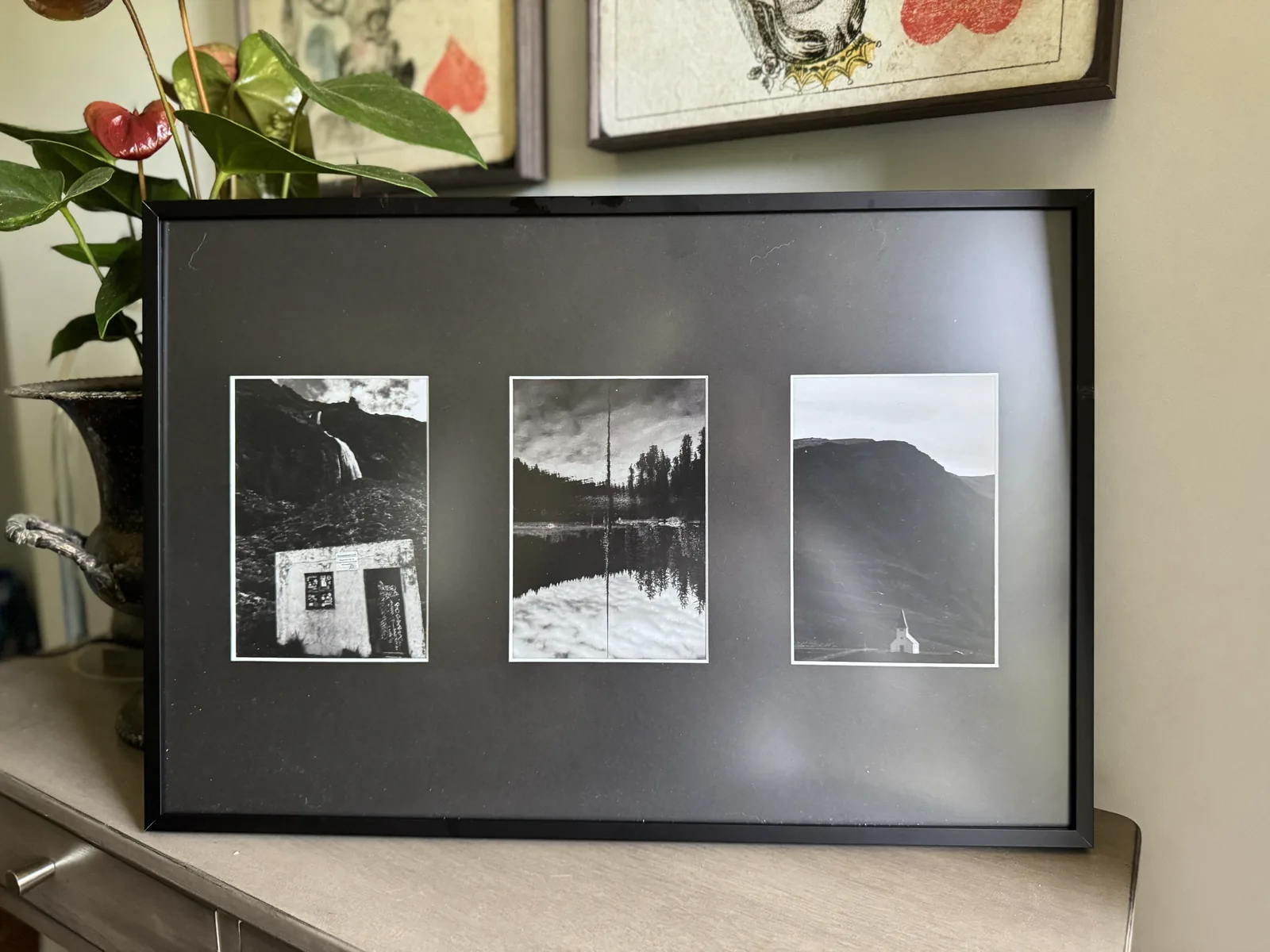 Black three-opening collage frame of black and white landscape photos