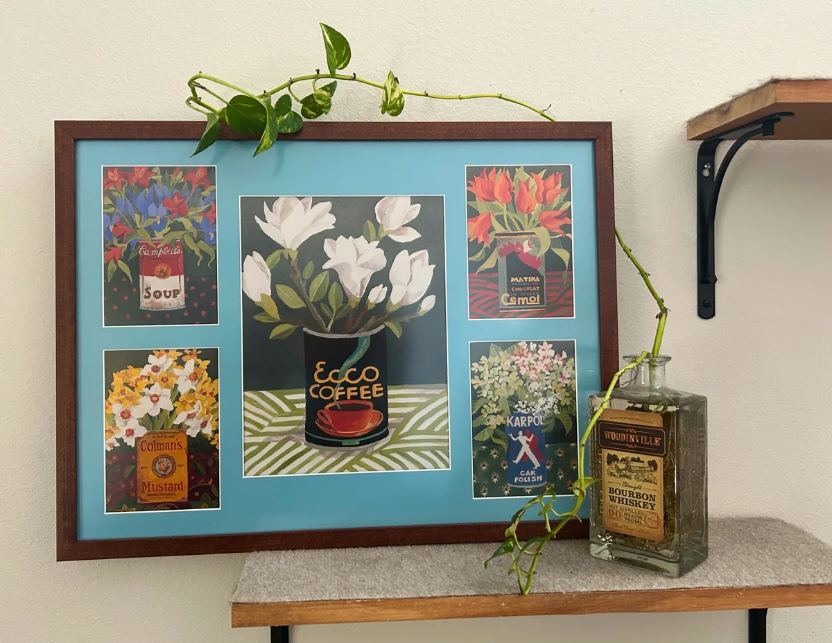 Wood collage frame with a teal matboard displaying vintage art prints