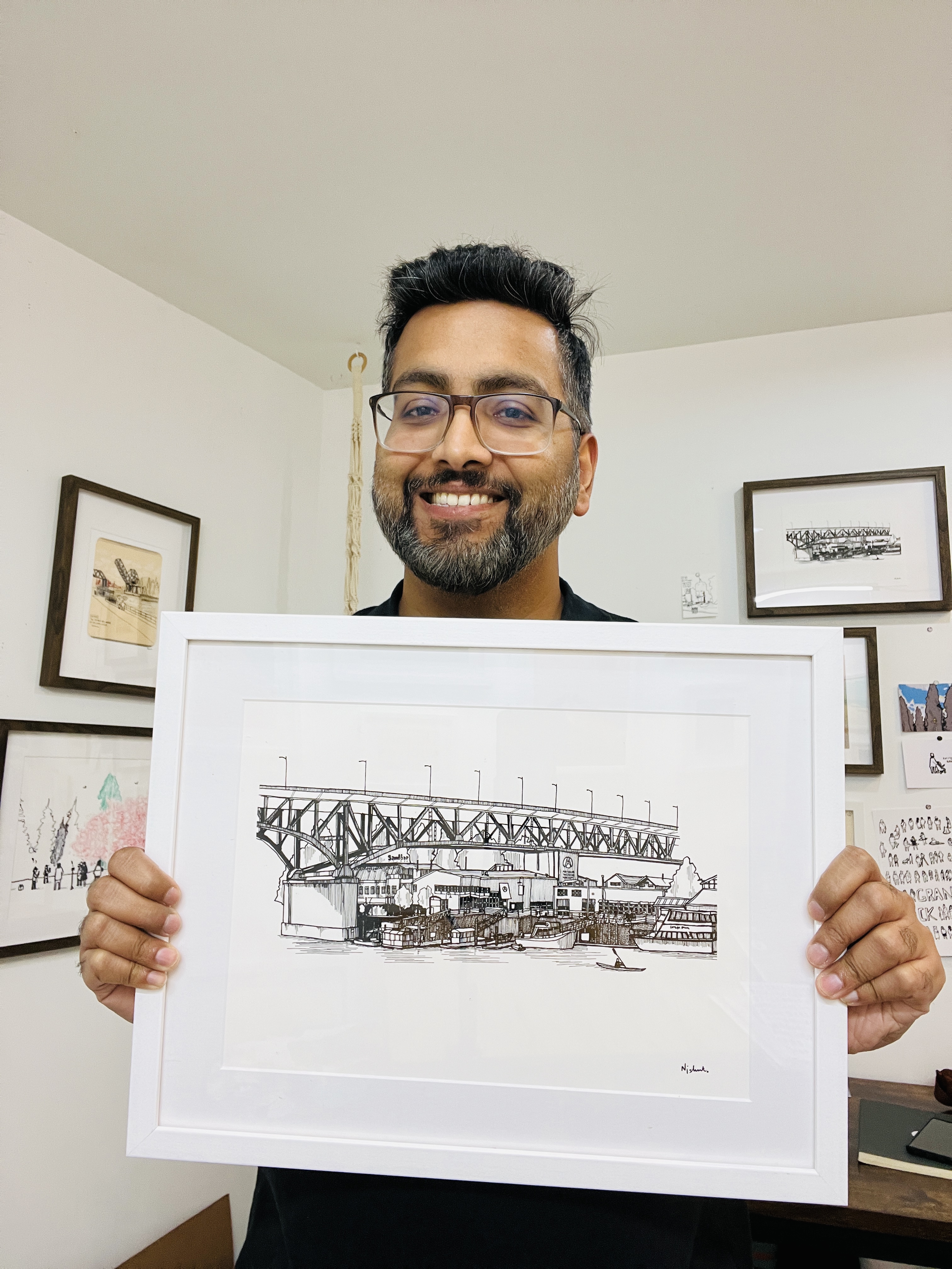 artist holding a small white picture frame