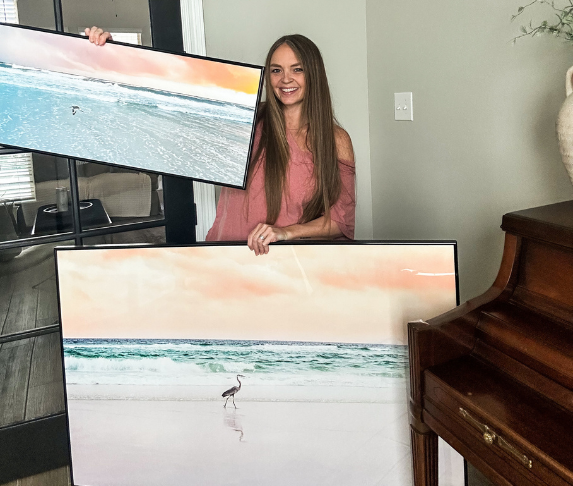 woman with coastal art prints custom framed