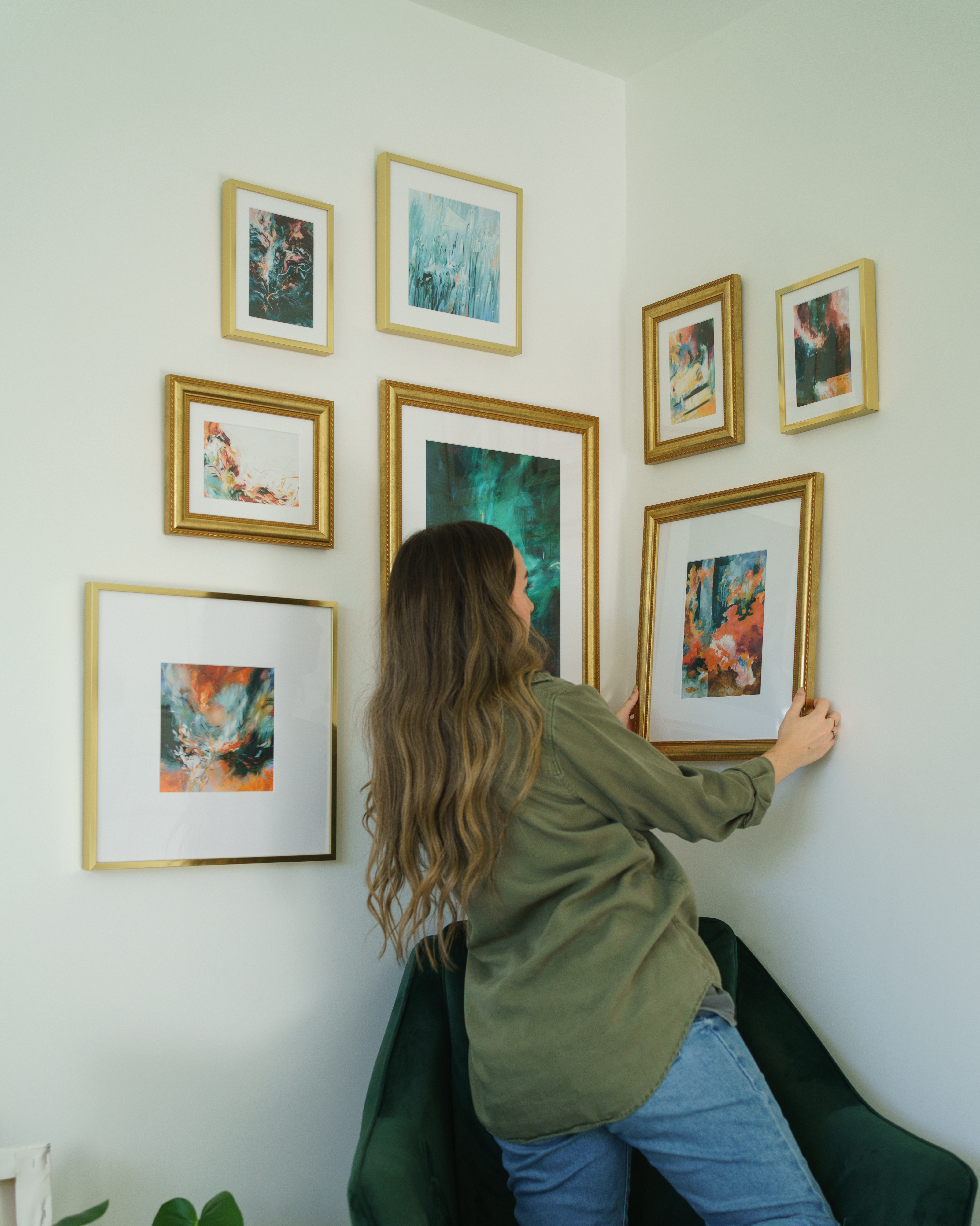 gallery wall of gold picture frames