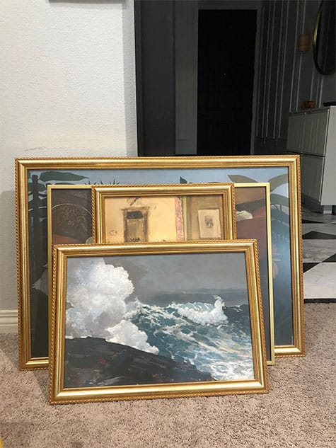 Several gold-framed painted artworks