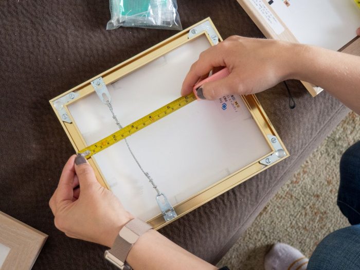 Using measuring tape to properly size a frame 