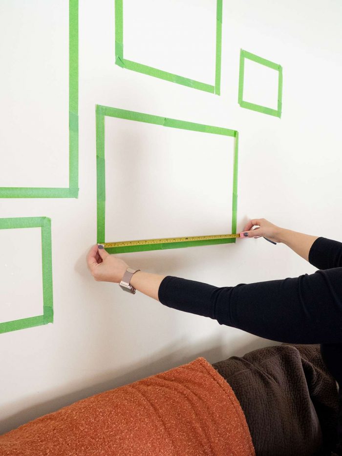 9 Steps To Start Decorating For Beginners: Designer Tips: Use painter's tape to hang picture frames