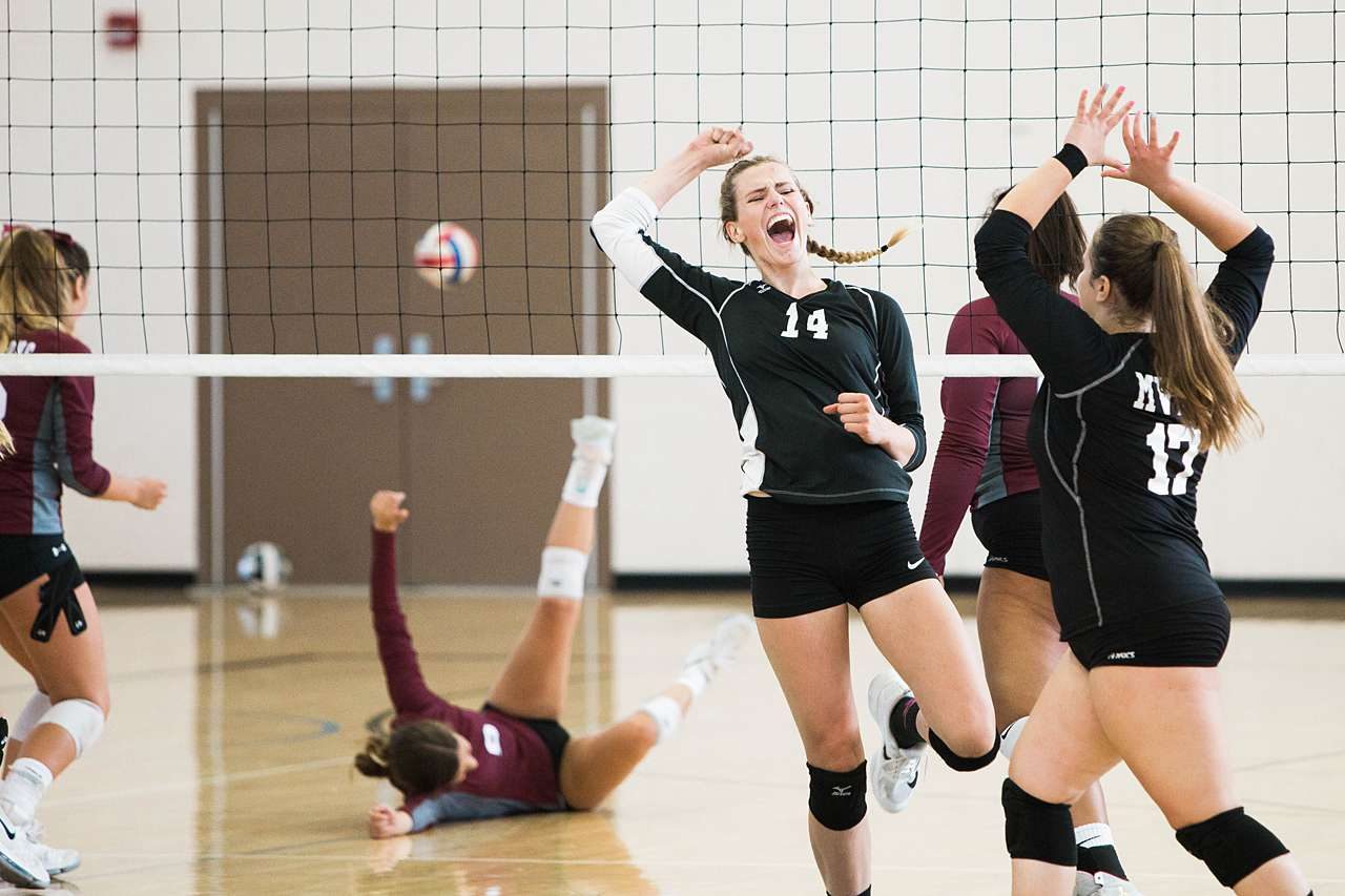 School volleyball team scoring a shot