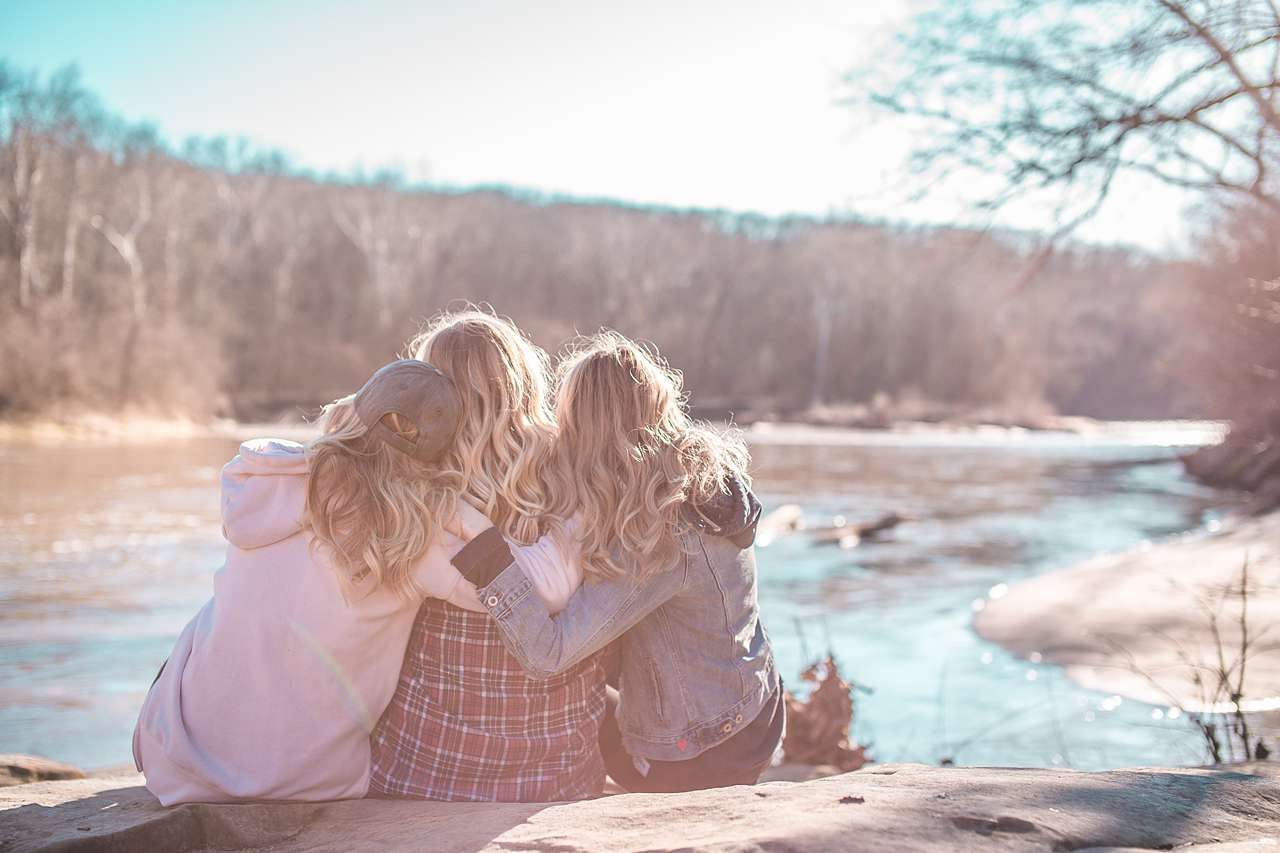 Three friends photo admiring creek in winter