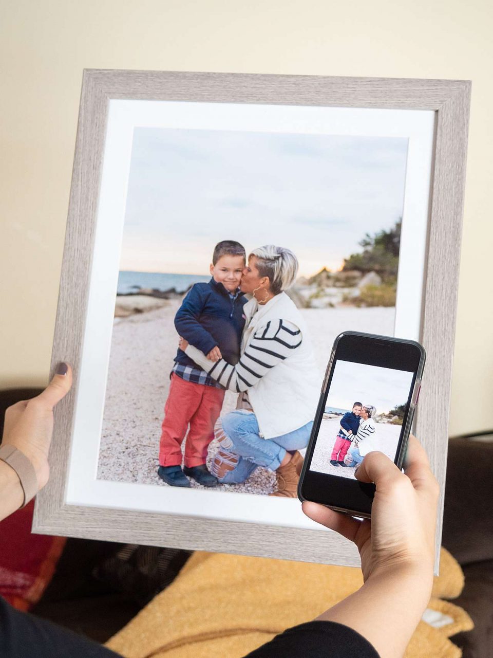 Phone taking picture of framed photo of mother and son