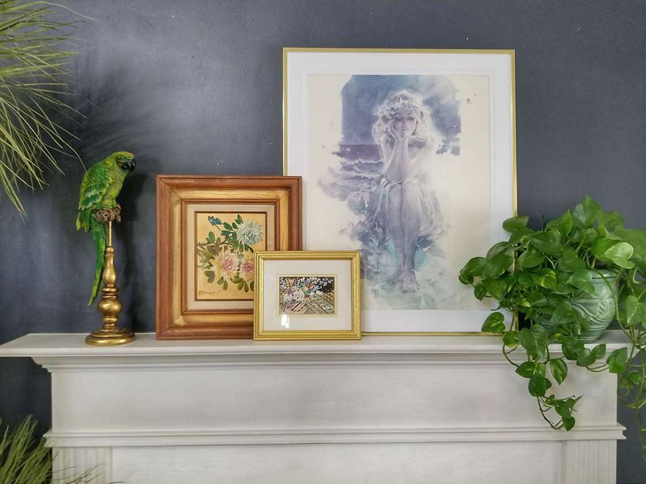 Triple picture frames on fireplace