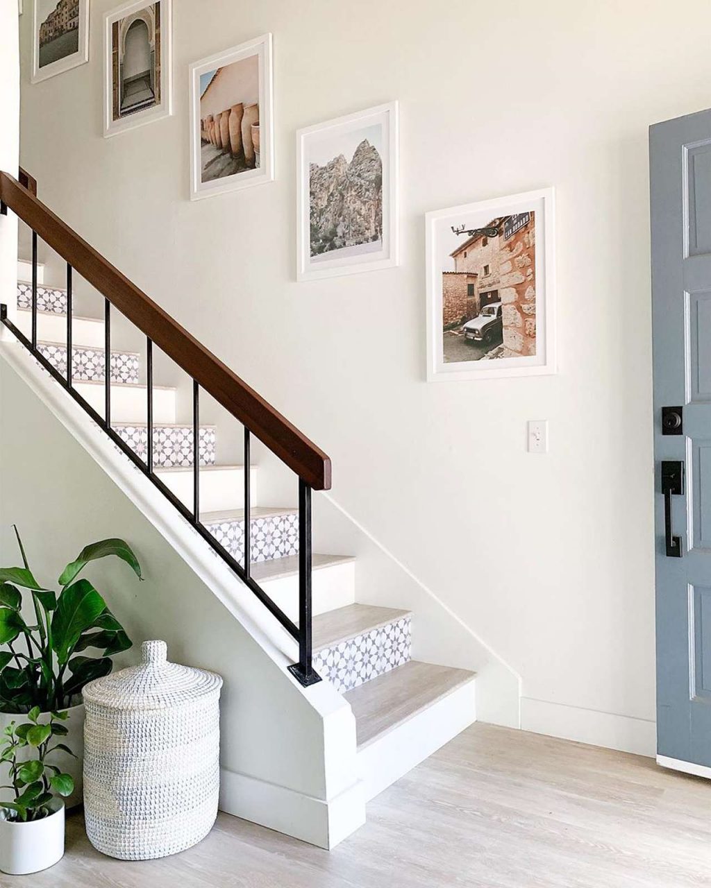 White picture frames on wall with staircase