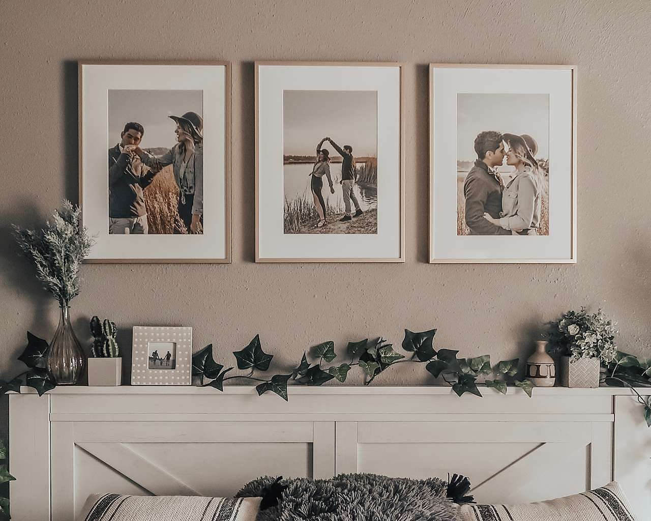 Triple picture frames above bed