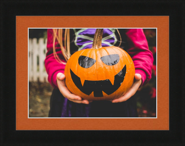 Fall art print - girl holding pumpkin painted like jack-o-lantern - Dayton in Black with Tangerine Matting