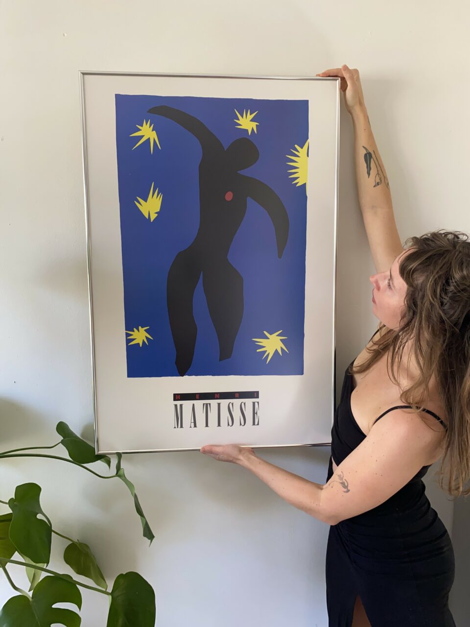 Large Picture Frames: How to Choose the Right Frame for Oversized Art 17 woman hanging large framed art