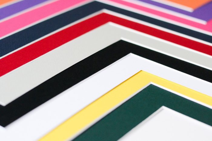 A variety of picture frame mats in different colors.