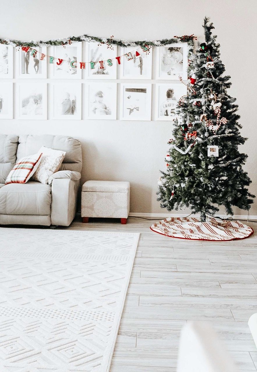 Christmas tree next to gallery wall