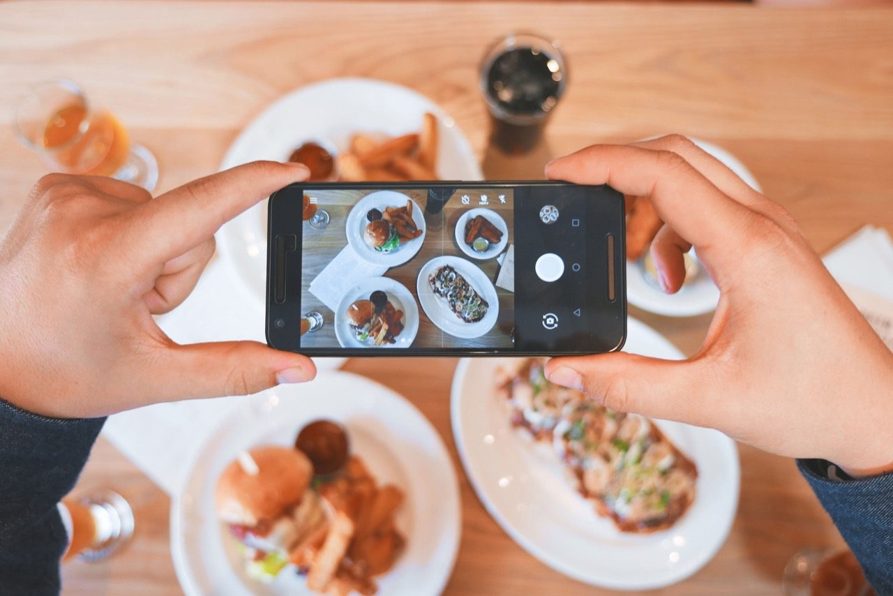 person taking a picture of food 