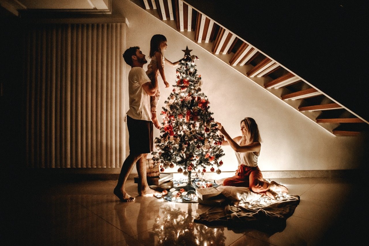 Family decorating the Christmas tree. 