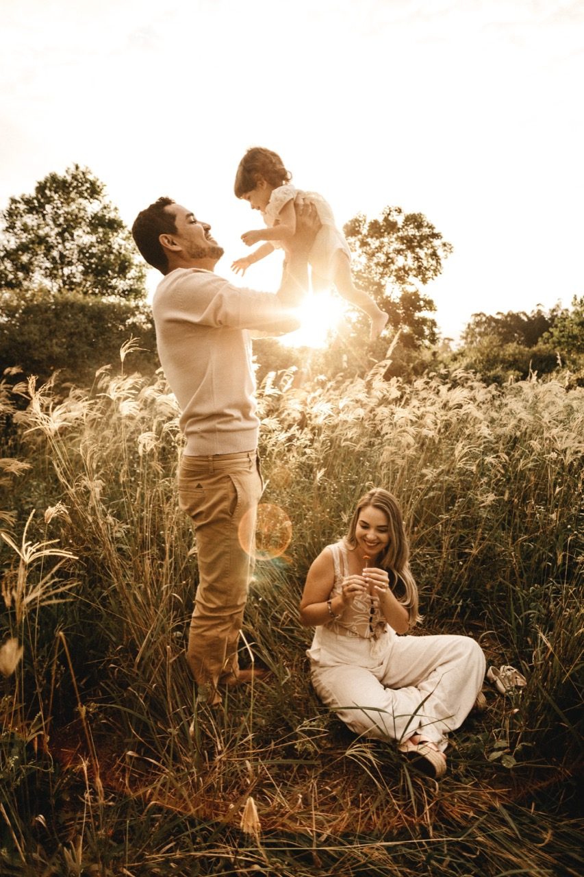 Family laughing in nature.