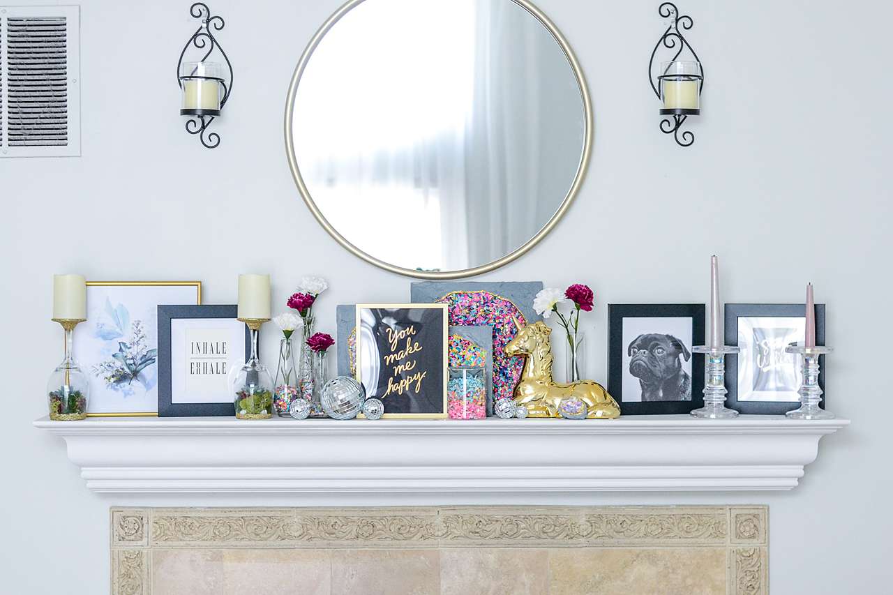 Different size and color frames on mantel 