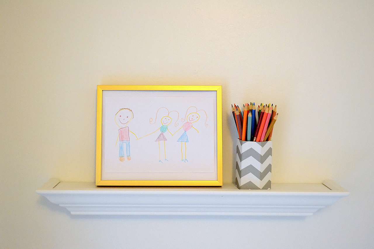 framed drawing of stick figures