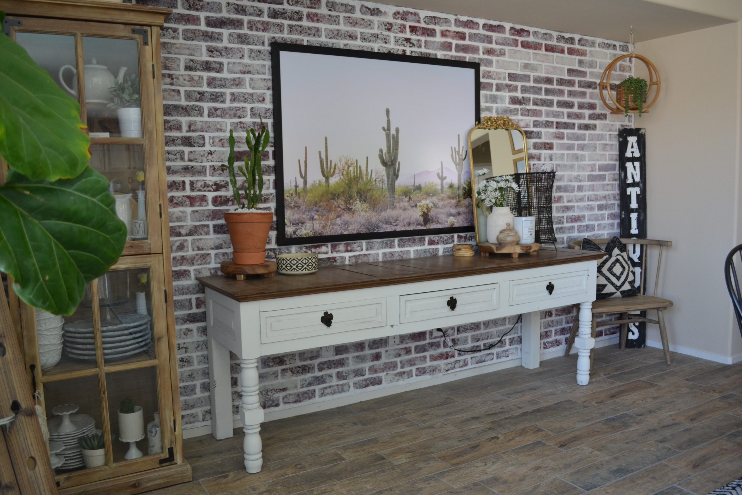 How to Hang a Frame on Any Wall: Brick kitchen wall with cactus art