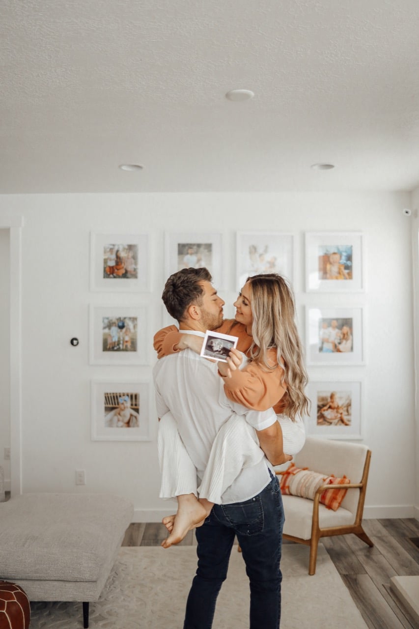 couple in front of gallery wall 