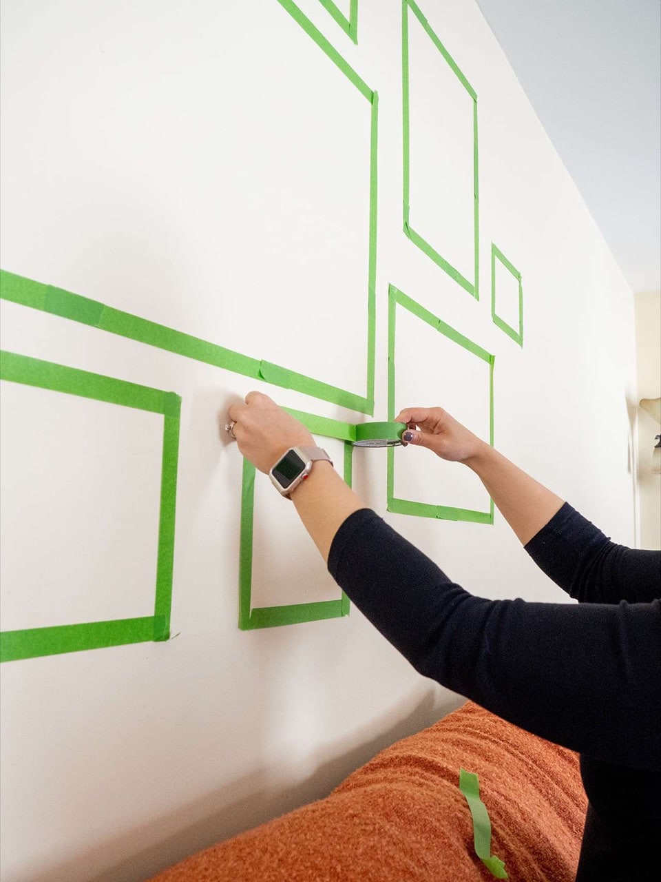 use painter's tape to plan where to hang frames 