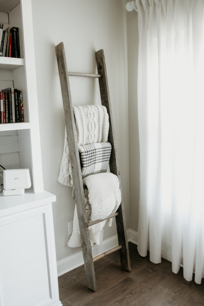 a ladder in a bedroom used as blanket storage. 