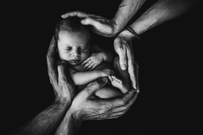 Newborn Baby Photo Ideas: A couple holding their baby
