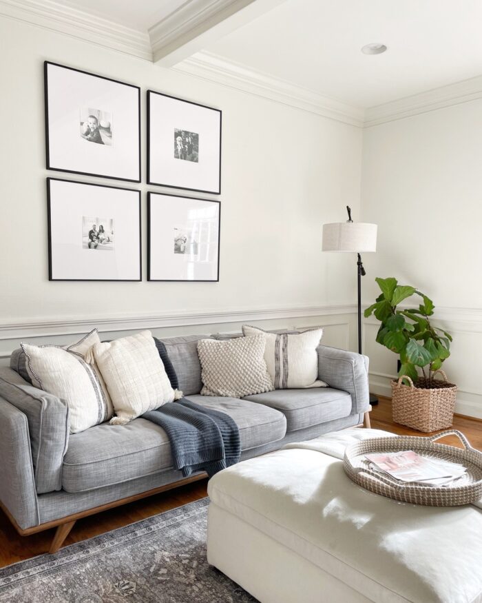 A family room with a framed grid gallery wall. 