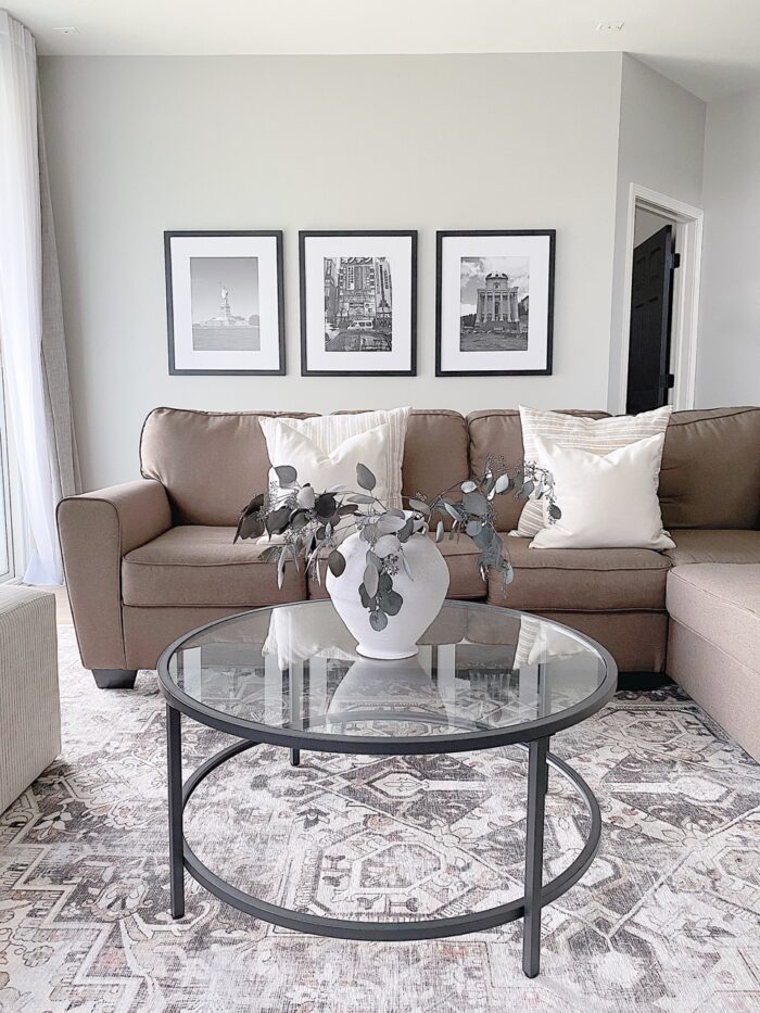 A living room with three framed travel photos. 