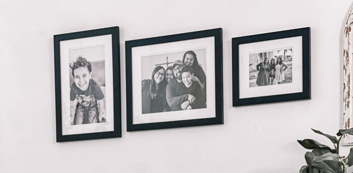 Framed family photos hung on a wall.