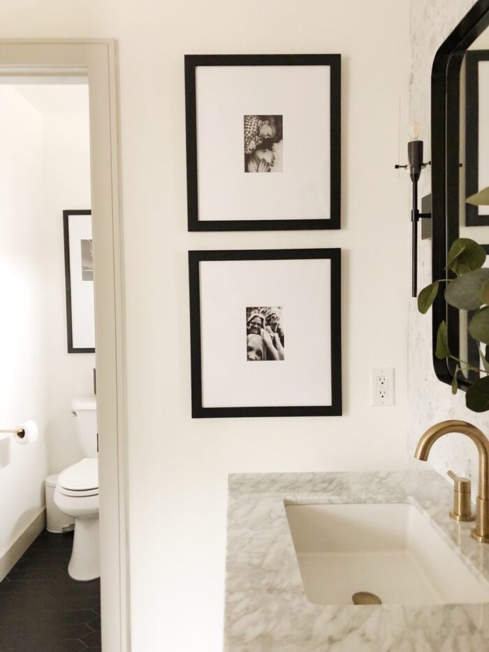 small framed photos in a small bathroom space.