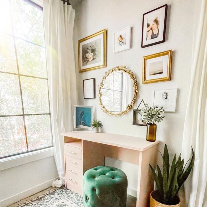 Mirror and framed photos above a desk