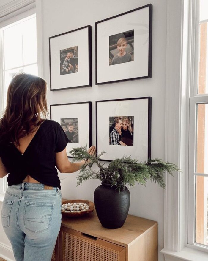 Photo Wall Ideas: A woman hanging framed photos