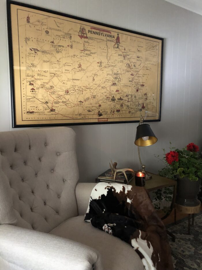 an old map framed and hung over an armchair. 
