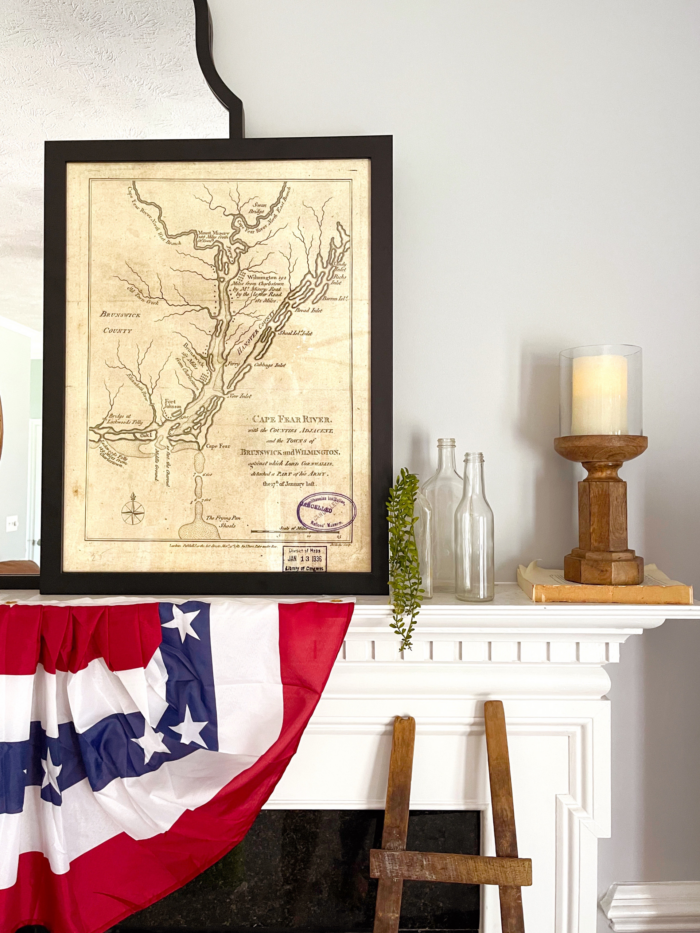 Home Staging Art and Decor Ideas - Framed vintage map on fireplace.