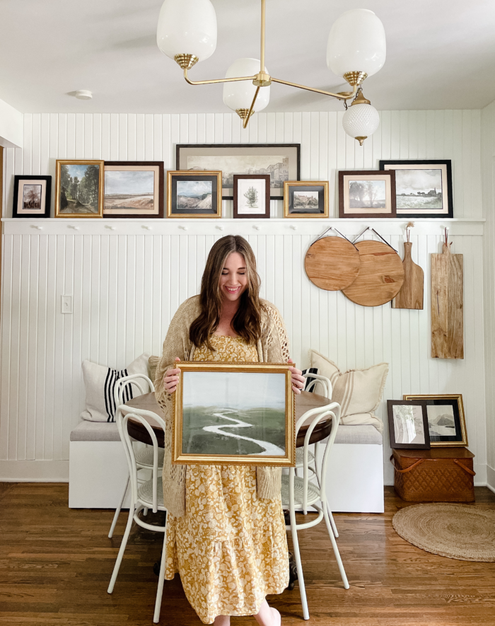 A lady holding a framed art print