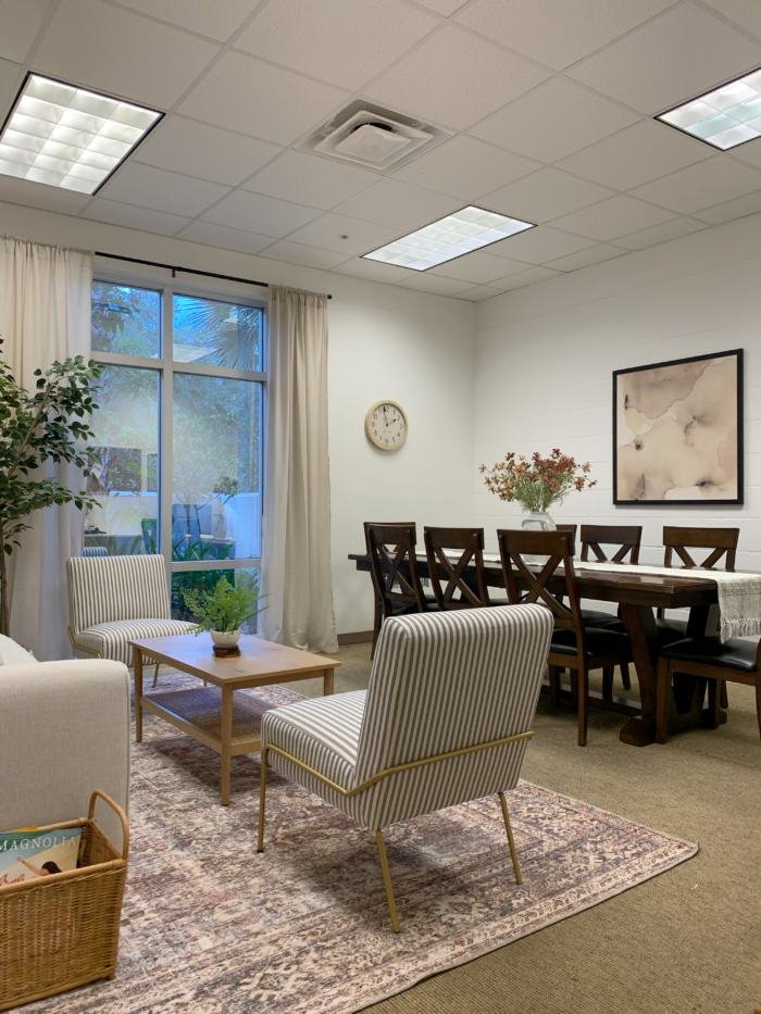 Teacher's lounge decor with comfortable seating and plants.