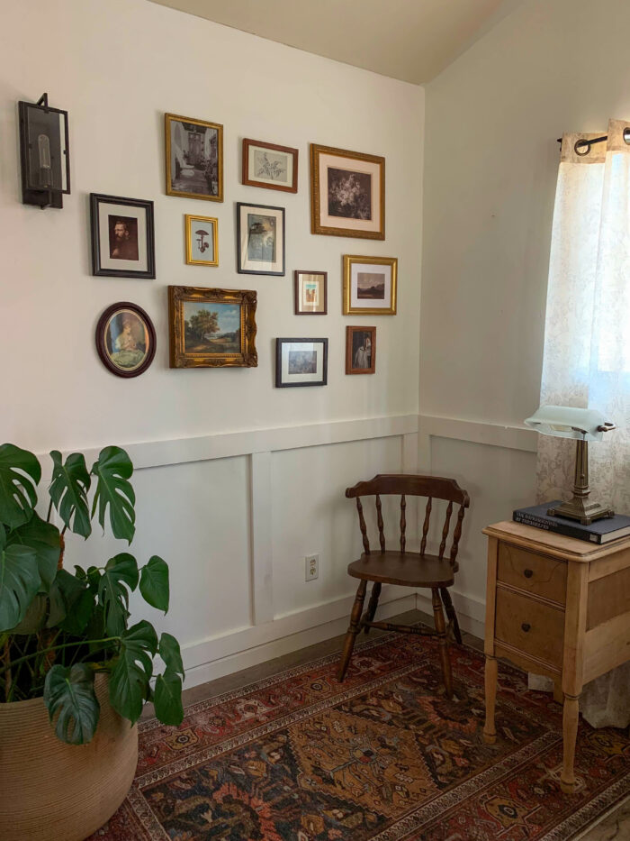 Framed cottagecore art prints in an office with a vintage chair and plant.