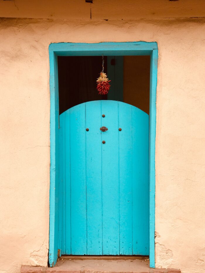 Southwestern decor: Turquoise garden gate on an adobe building. 