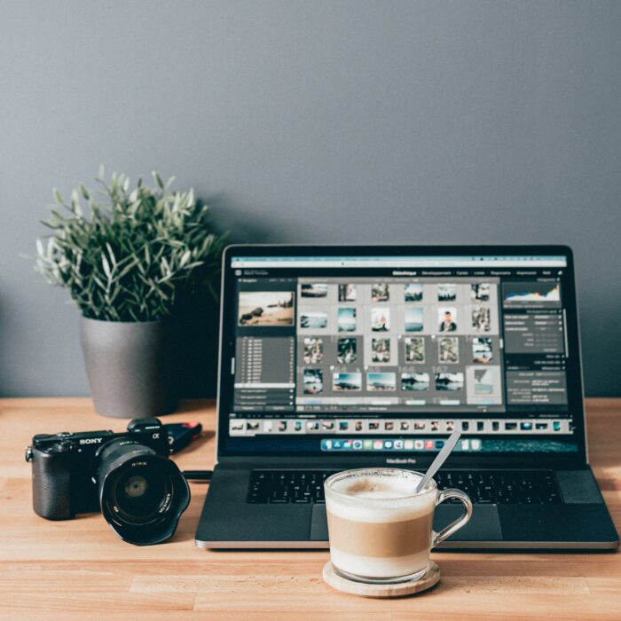 How to Take Professional Headshots: Computer and camera on a desk.