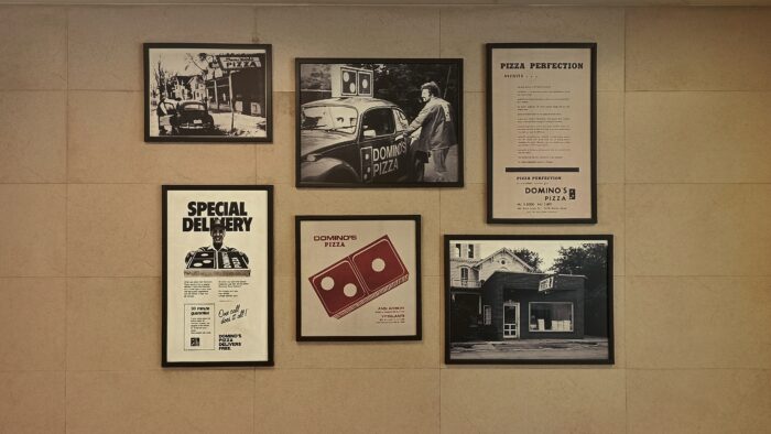 Framed newspaper pictures and ads.